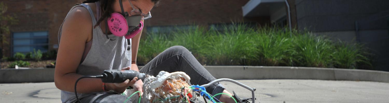 Sculpture student working outside