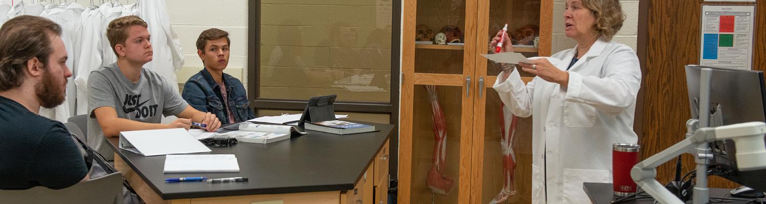 Students in classroom with science professor