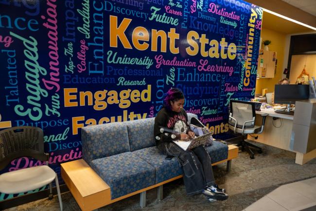 Geauga student sitting in an on-campus lobby