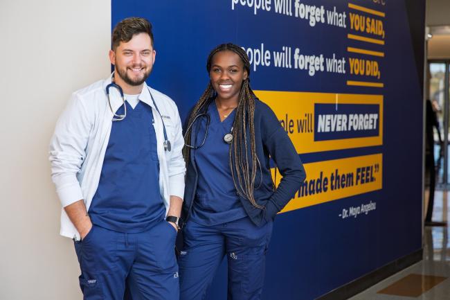 Two nursing students standing in front of Geauga signage