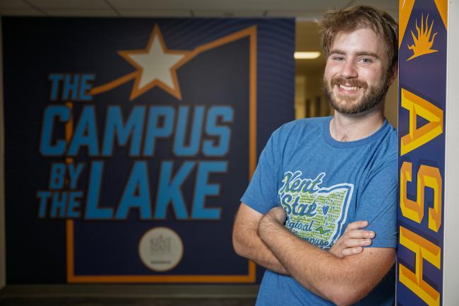 Student posing in front of an Ashtabula sign