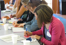 Teachers writing at a table