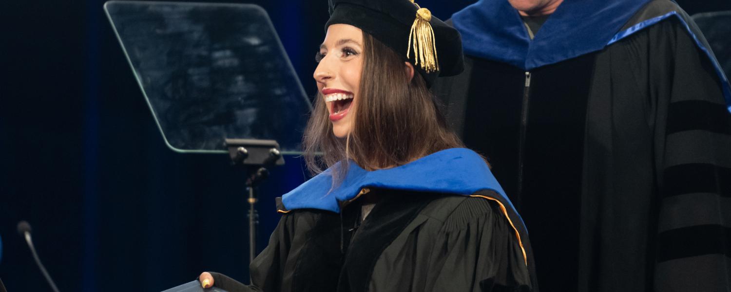 student receiving diploma