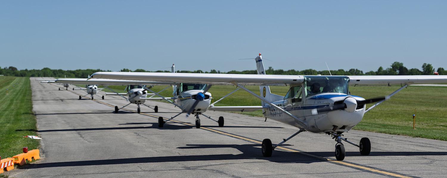Five planes piloted by Kent State students from Rwanda line up before takeoff. (Photo credit: Bob Christy)