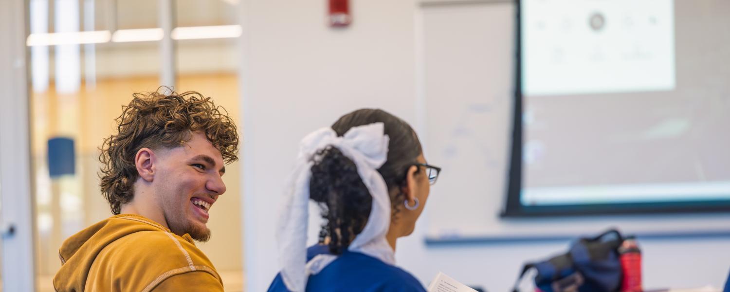  An upward-bound student talking to a fellow classmate. 
