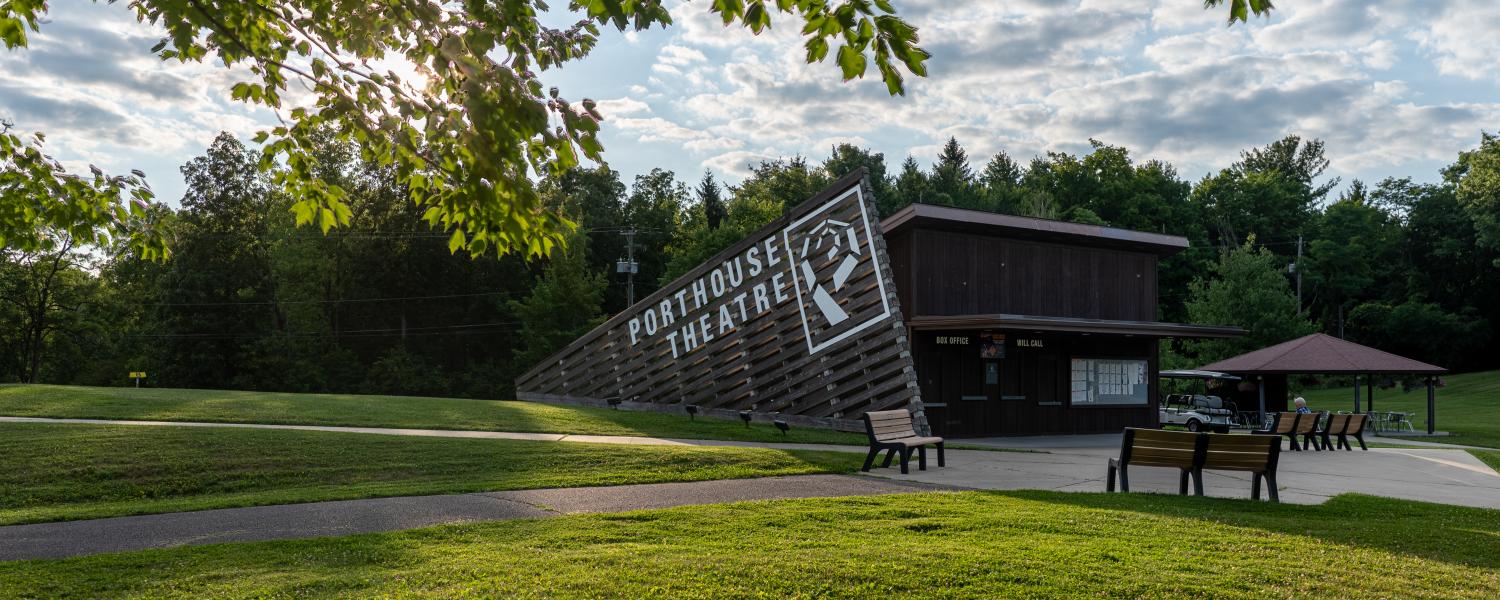 Porthouse Theatre sign framed by summer foliage