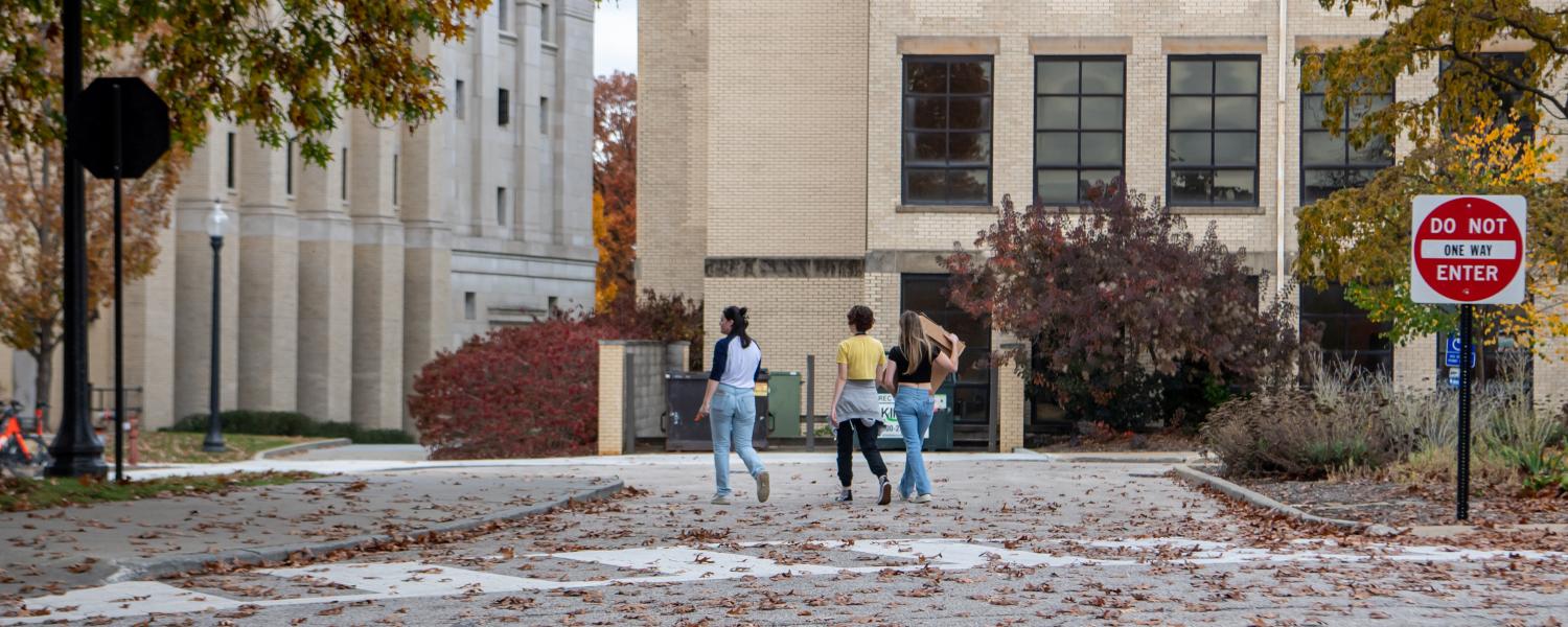 A photo of young students walking across campus