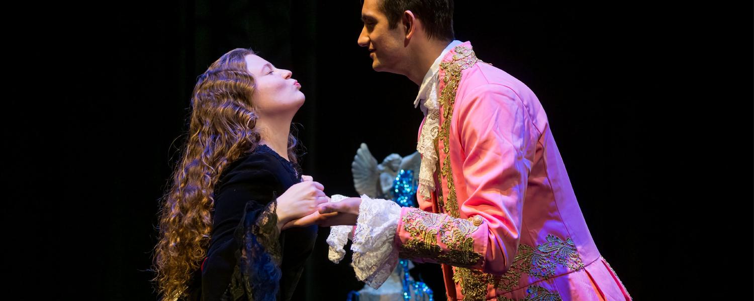 Two people on stage during a KSU opera performance. 