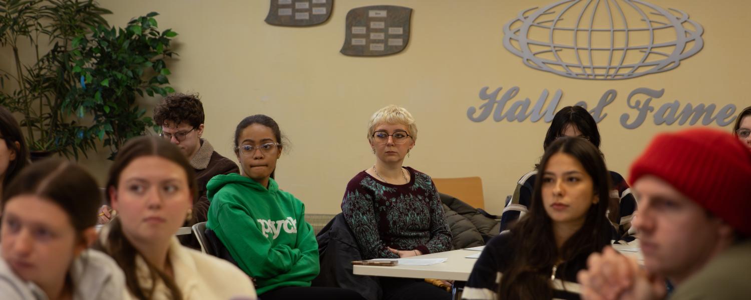 Counselor Education and Supervision master's students sit at tables during orientation