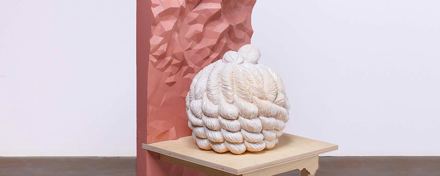 Photo of a sculpture of a abstract chair with a spikey sphere sat on it