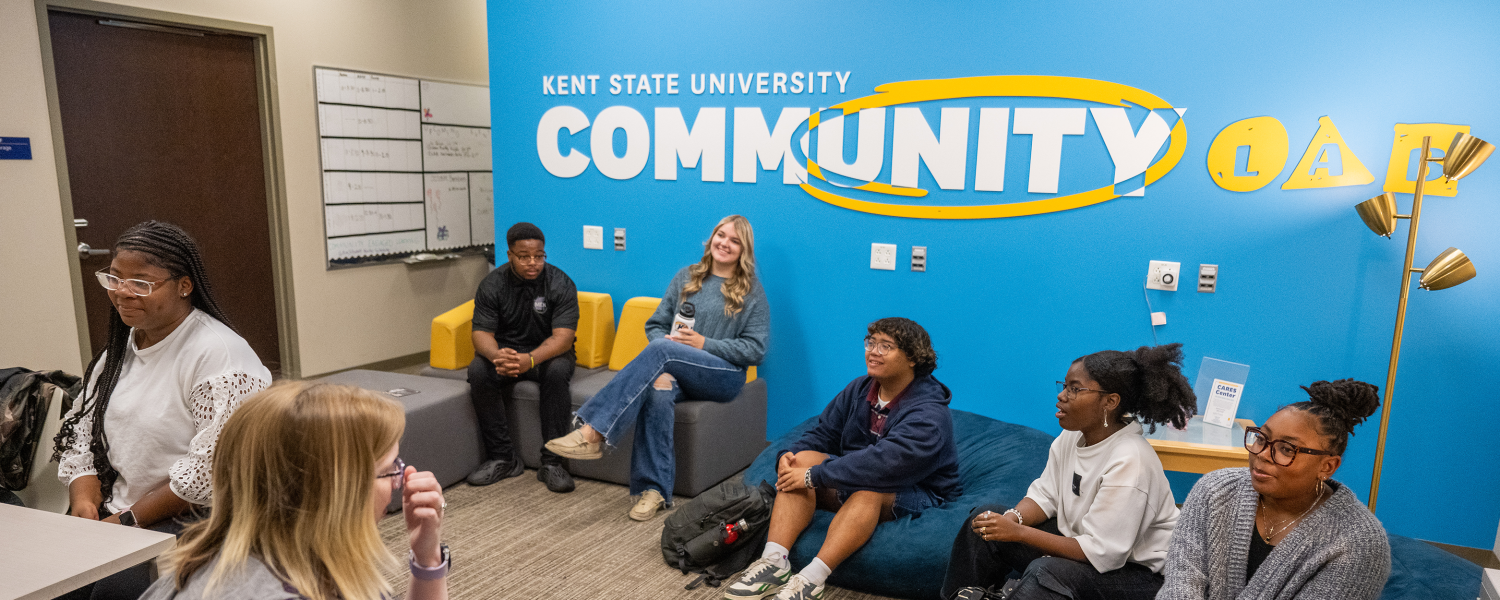 A group of students sit in the Community Lab and talk to each other.