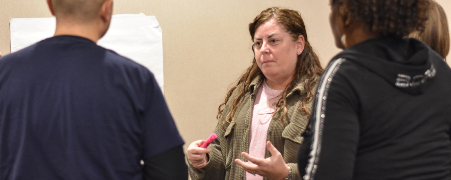 A member of the Equal Opportunity and Compliance team presenting to a group of employees.