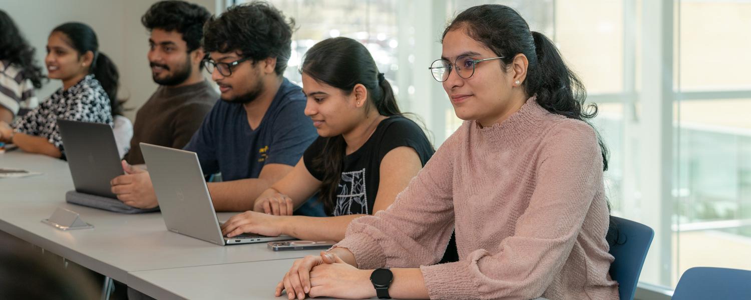 students smiling in business analytics mba class