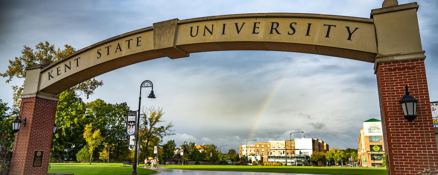 Closeup of the 51�Թ��� Arch, reading 51�Թ���, with a partially cloudy sky and a rainbow in the background