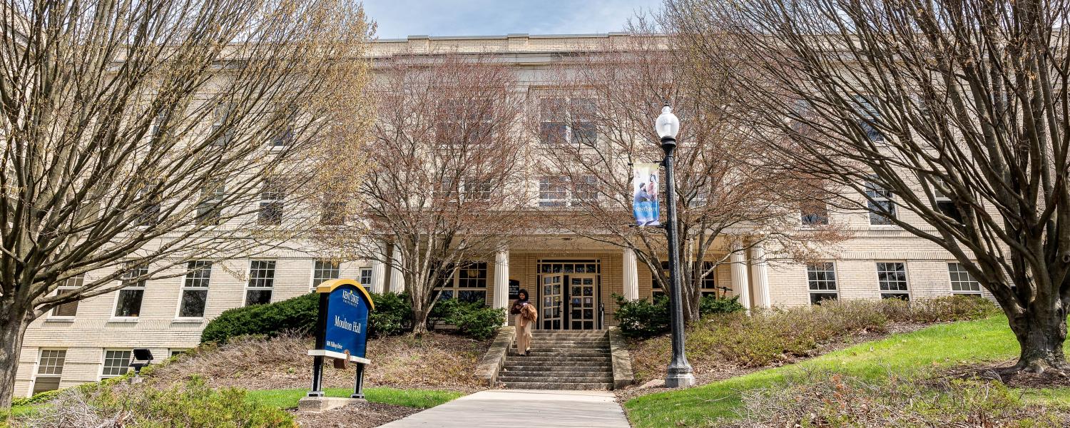 Student walking in front of Moulton Hall
