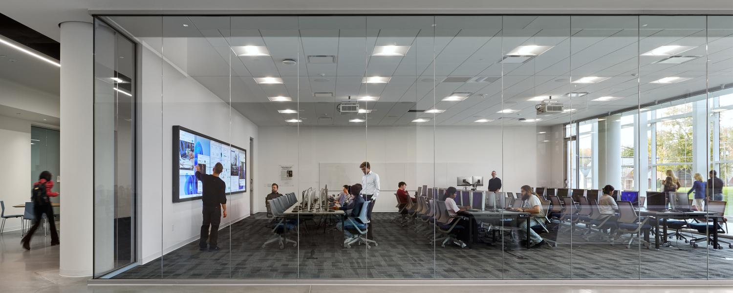 Student giving presentation in business analytics computer lab