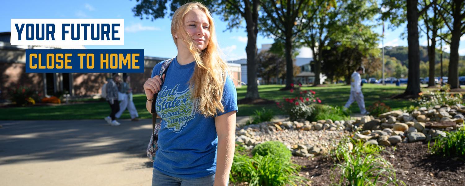 Student standing in front of a building at Kent State Tusc