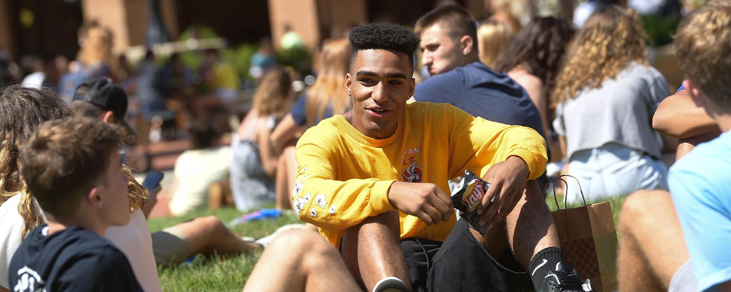 Photo of a ɬ student sitting outside.