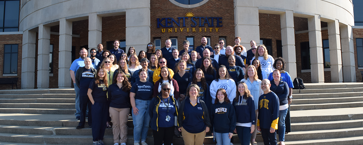 The entire University College staff stands in front of the MACC building on campus.
