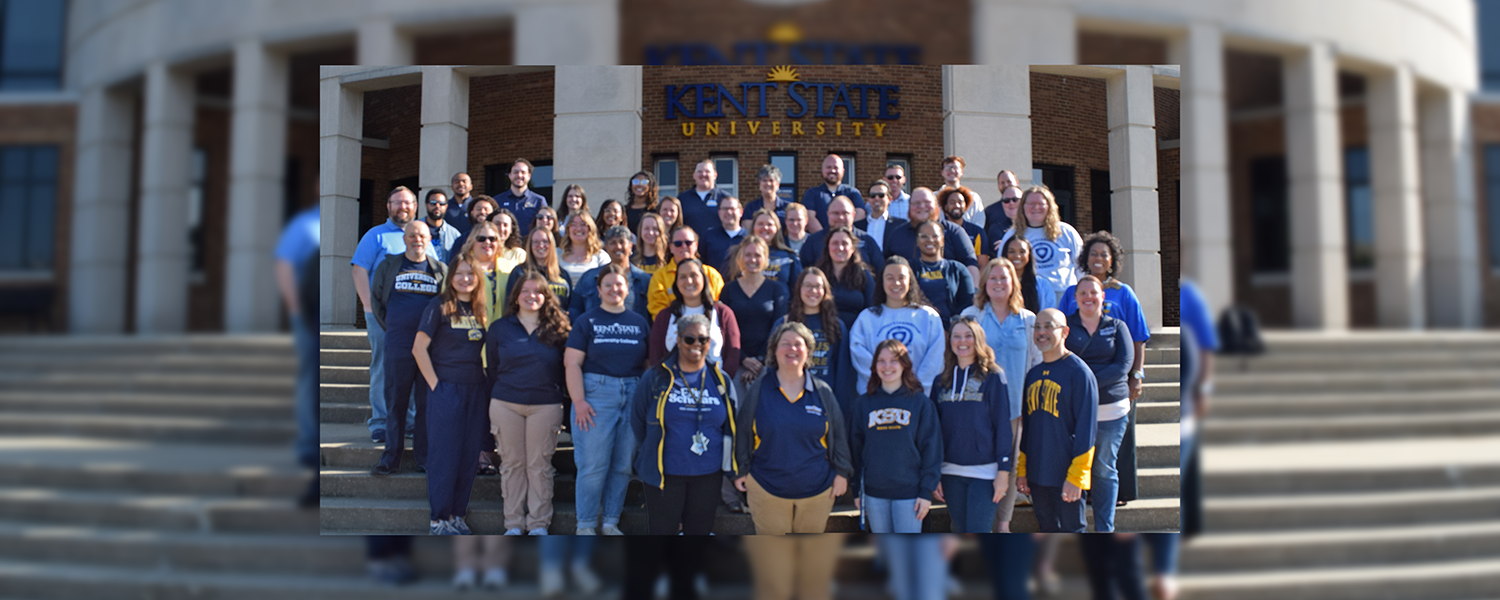 The entire University College staff stands in front of the MACC building on campus.