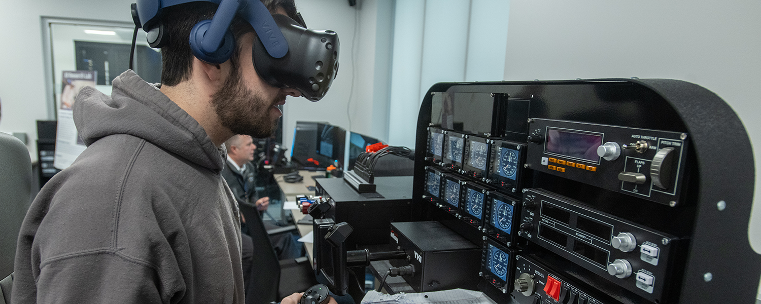 A student uses extended reality in a flight simulation
