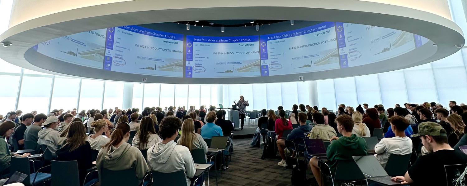 Accounting professor teaching in the global forum.