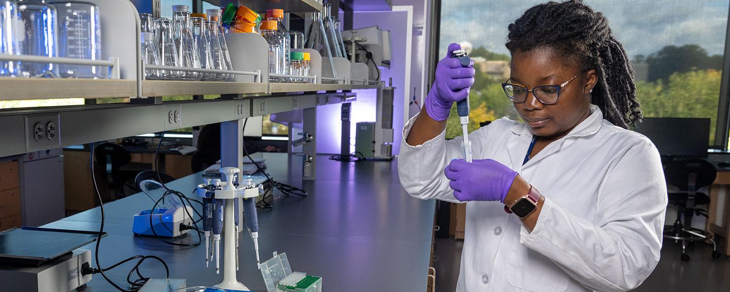 Student performs an experiment in a lab.