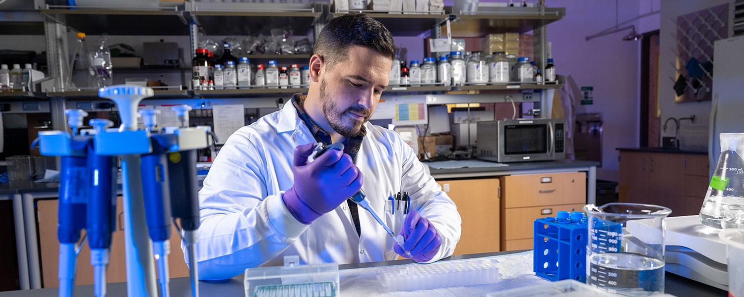 Man performs experiment in lab