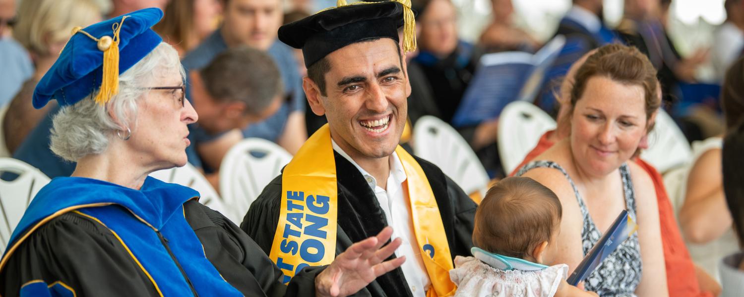 University Macebearer holding the Mace during the Academic Processional