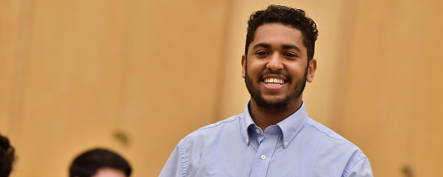 Student in classroom smiling