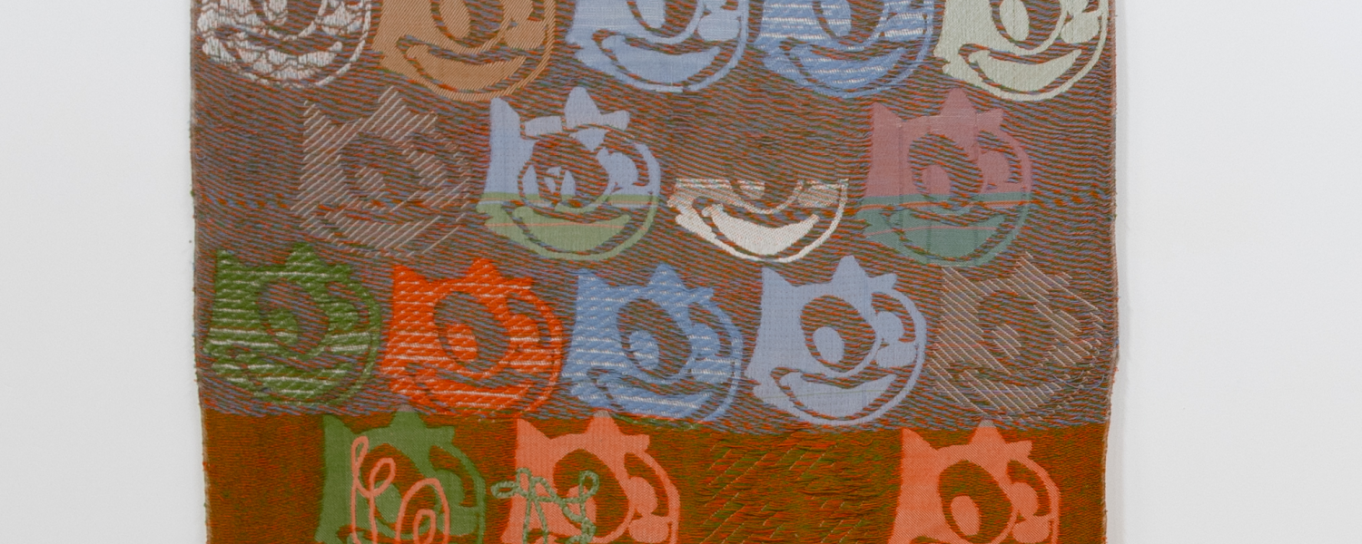 photo of a textile artwork depicting a character's likeness repeated throughout