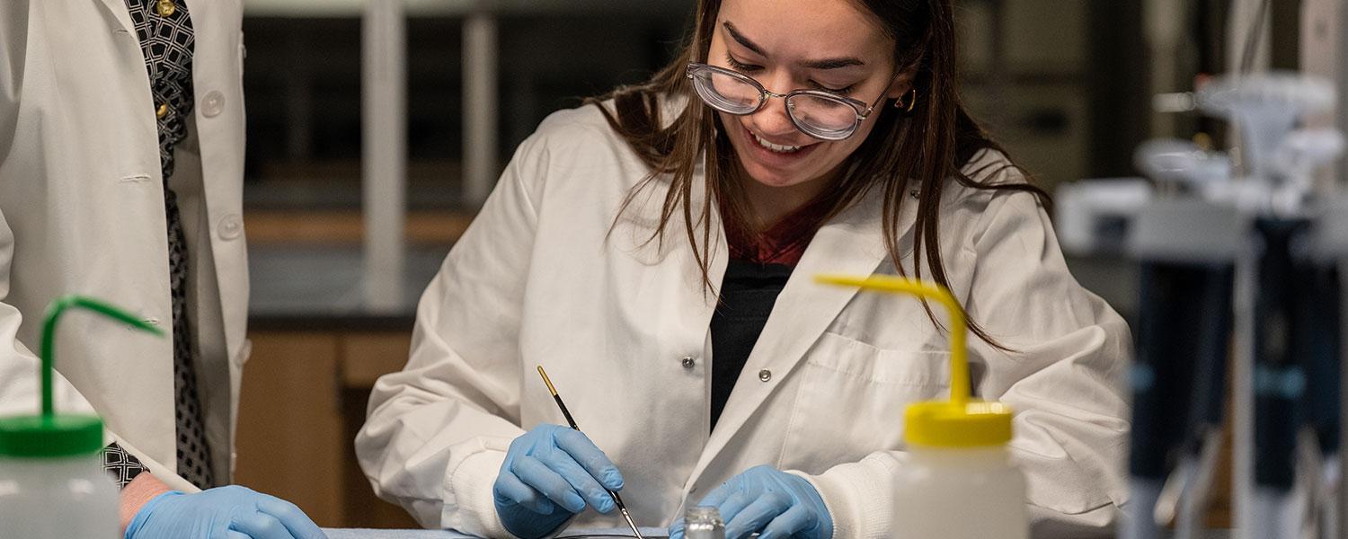 Student performs experiment in lab