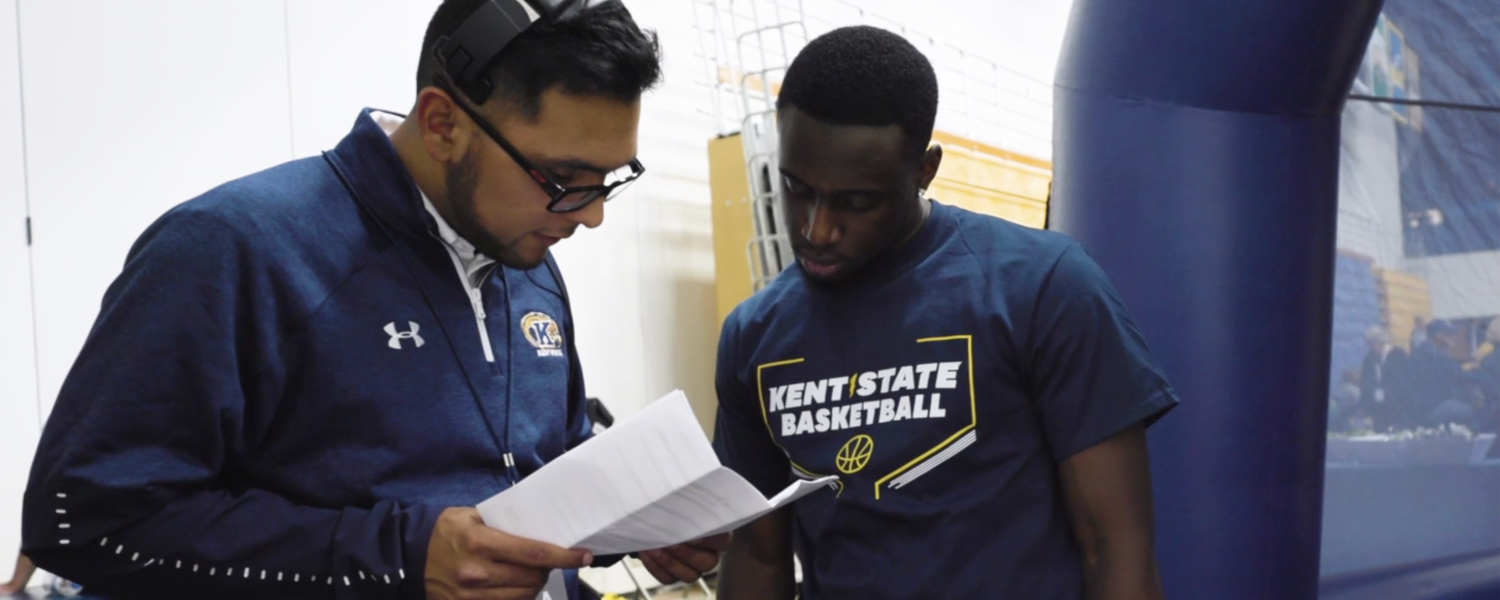 Sport administration student working with basketball player.