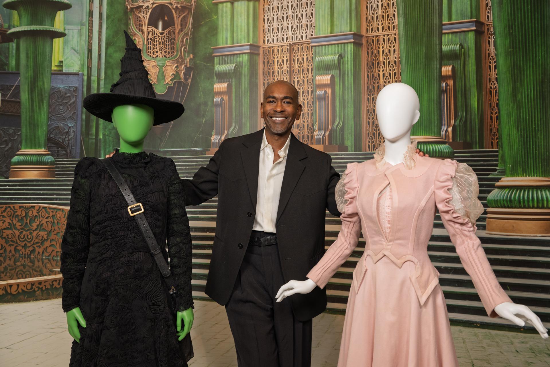 Paul Tazewell with Elphaba and Glinda outfits