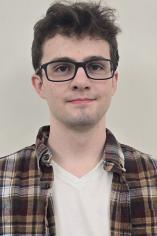 image of a male student wearing flannel and plain white inside tshirt wearing eyeglasses