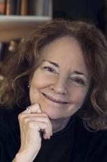 Woman smiling with hand under her chin