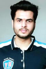 Picture of male student wearing dark blue t-shirt.