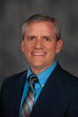 Photo of man in suit on gray background