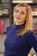Headshot of Alessandra smiling at camera, her long hair is straight and blonde