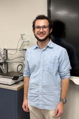 Caden Clark standing next to a Bambu Labs A1 printer