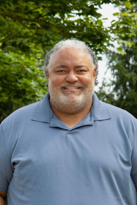 Photo of Carl wearing a blue shirt