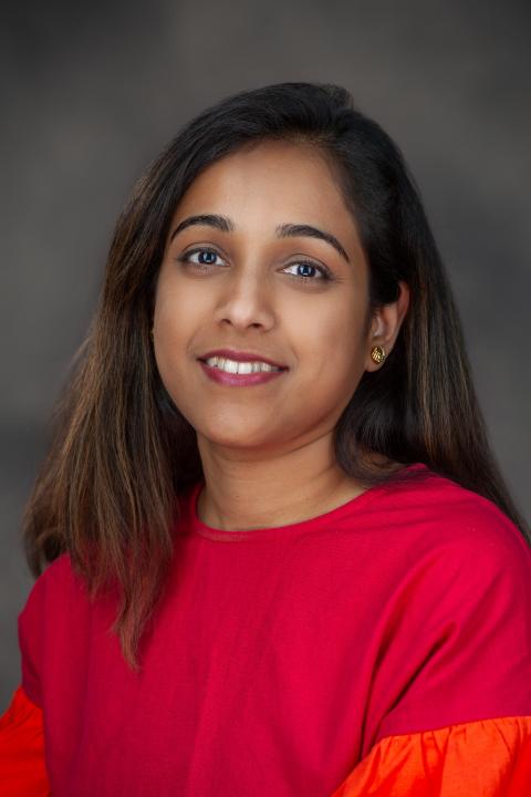Woman with dark hair and red blouse