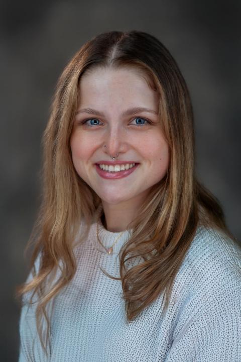 Professional headshot of Ren Hackley who is smiling at the camera