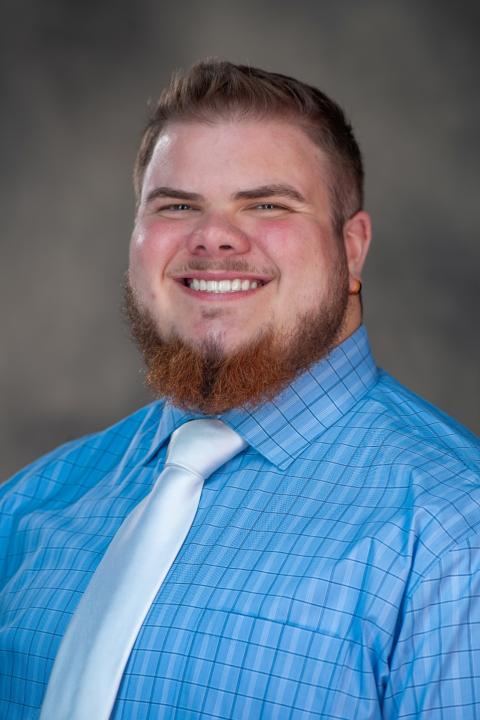 Professional headshot of Alex Harper