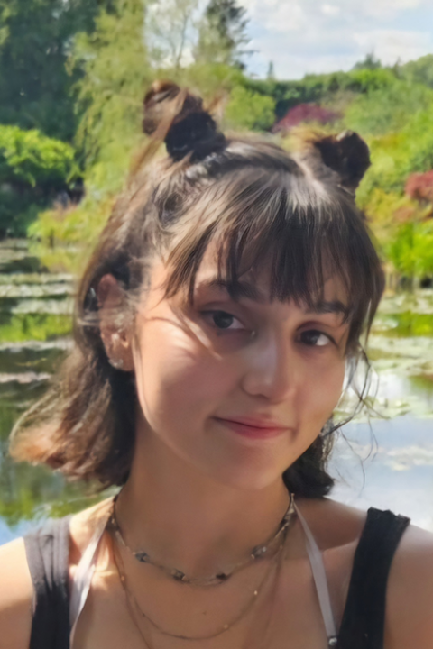 Sarah Burger smiling in front of outside scenery