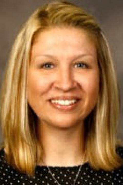 Shannon Reesh smiles in a professional headshot against a neutral background.