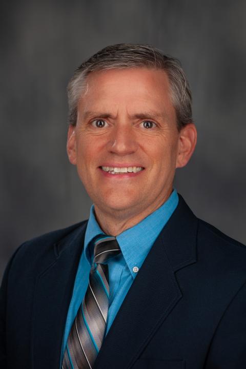 Photo of man in suit on gray background