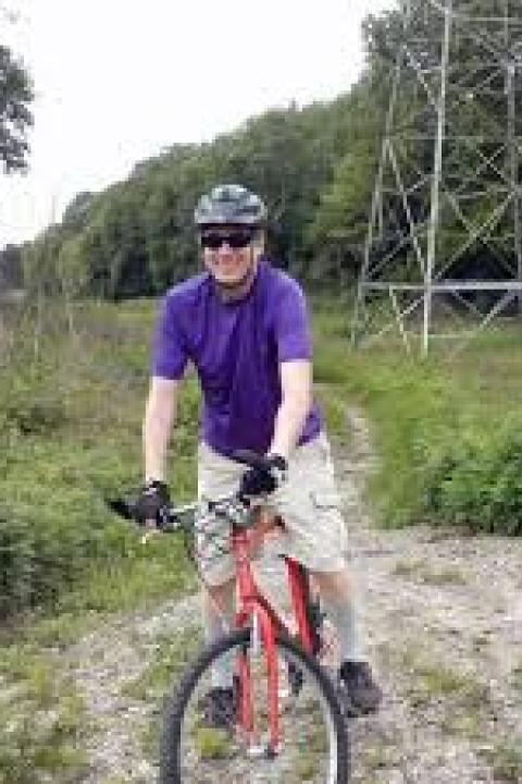 Darrell R. Ulm profile image, on mountain bike on path