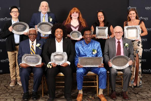 2025 Alumni Award recipients standing in a group, holding their awards