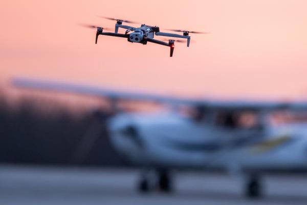 drone with airplane parked in background